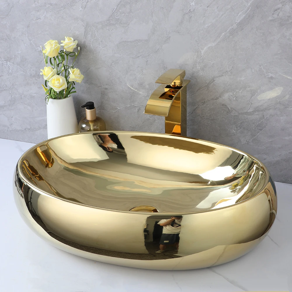 ZAPPO 23 Inch Bathroom Vessel Sink Gold Ceramic Sink Bowl Above Counter Oval Bathroom Sink with Waterfall Faucet Drain Combo