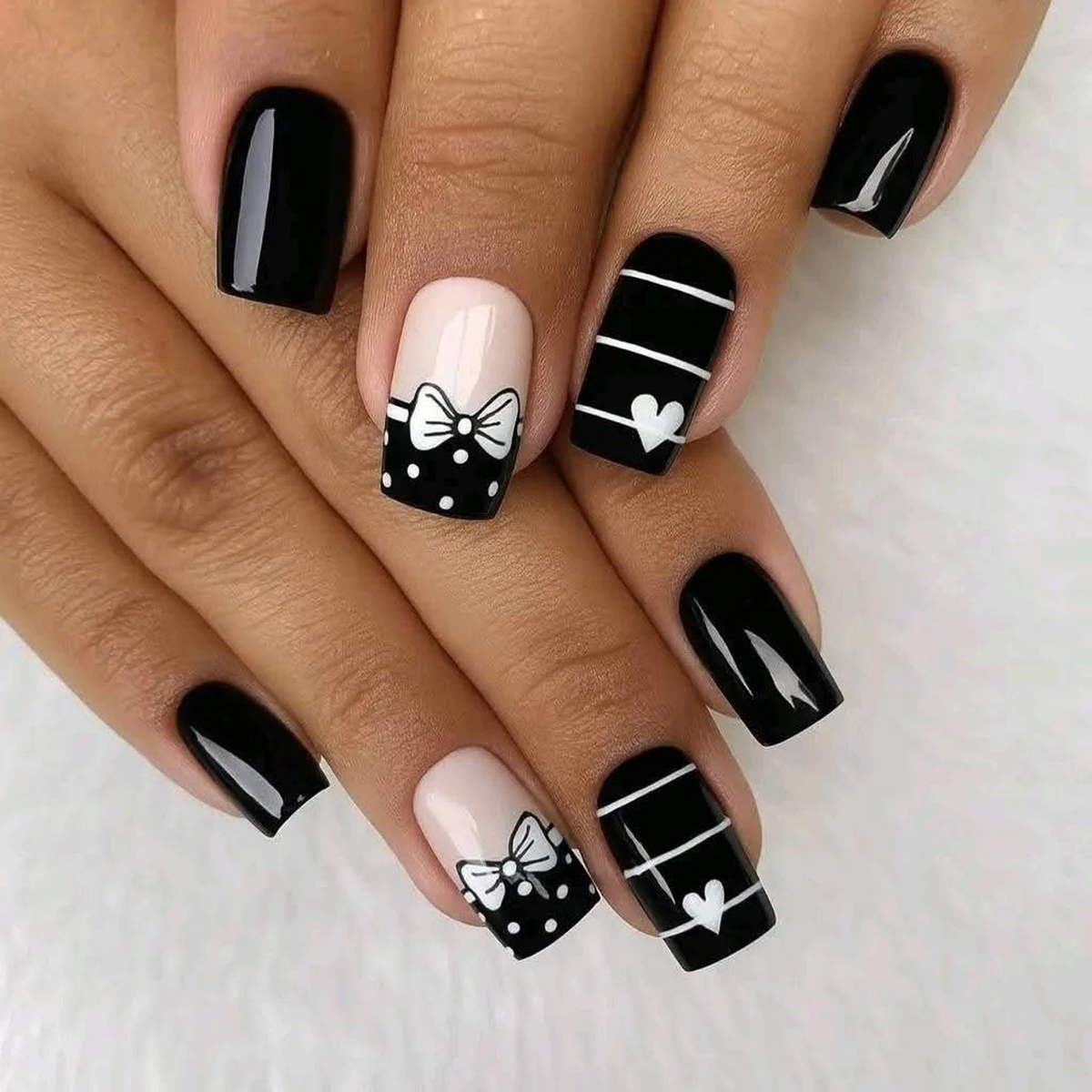 Full set of 4 packs/96 short square false nails, featuring classic black and white style with bows and heart prints, perfect for