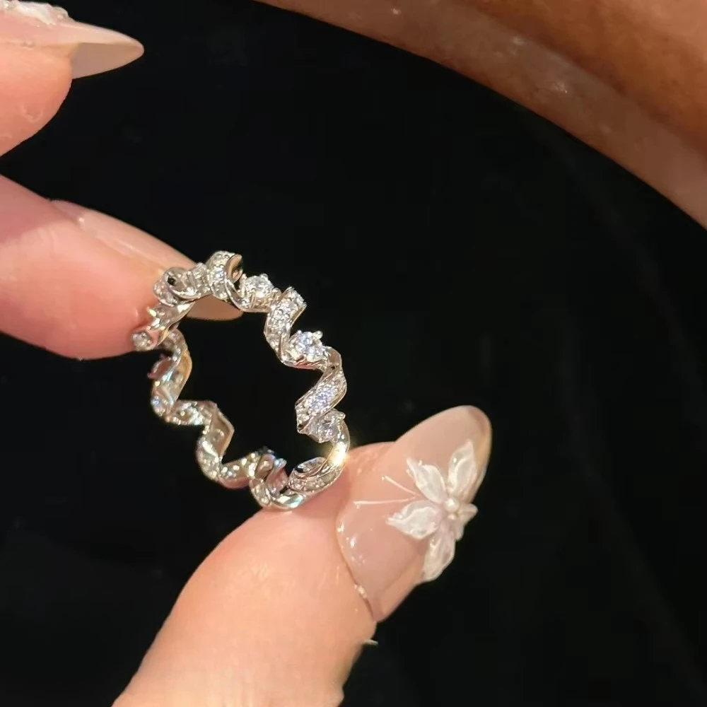 A delicate 925 sterling silver ring featuring a diamond-encrusted telephone wire design, suitable for ladies.