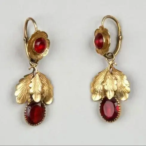 Retro-style copper earrings with red artificial gemstones and floral designs, suitable for casual travel wear.