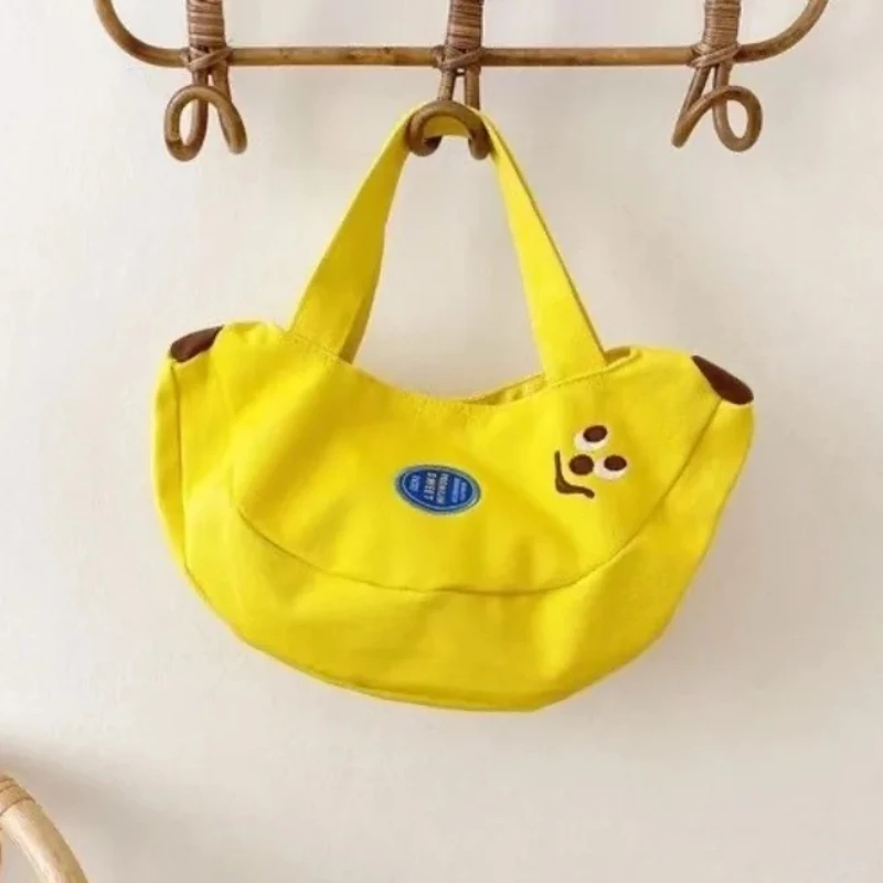 

New Cartoon embroidered canvas handbag portable and cute baby accessories for outdoor wear banana pouch office worker handbag