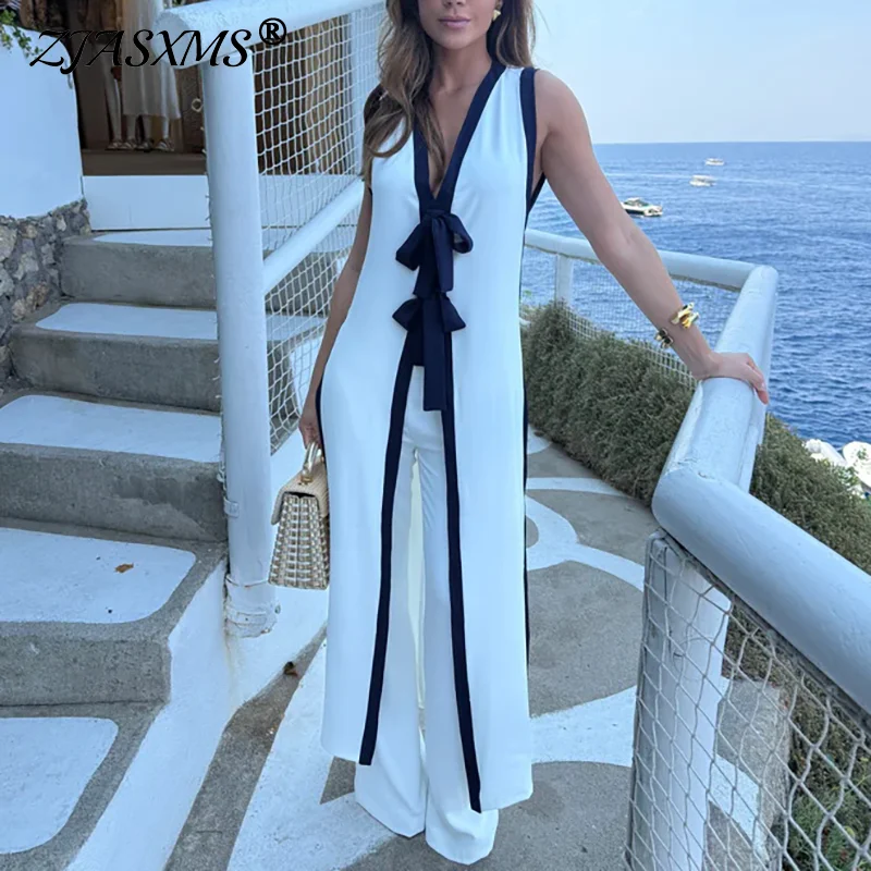 

Новинка! Летний женский комплект: элегантный топ без рукавов и брюки с высокой талией, в стиле колор-блок, с бантом. Идеально для отпуска и весны.