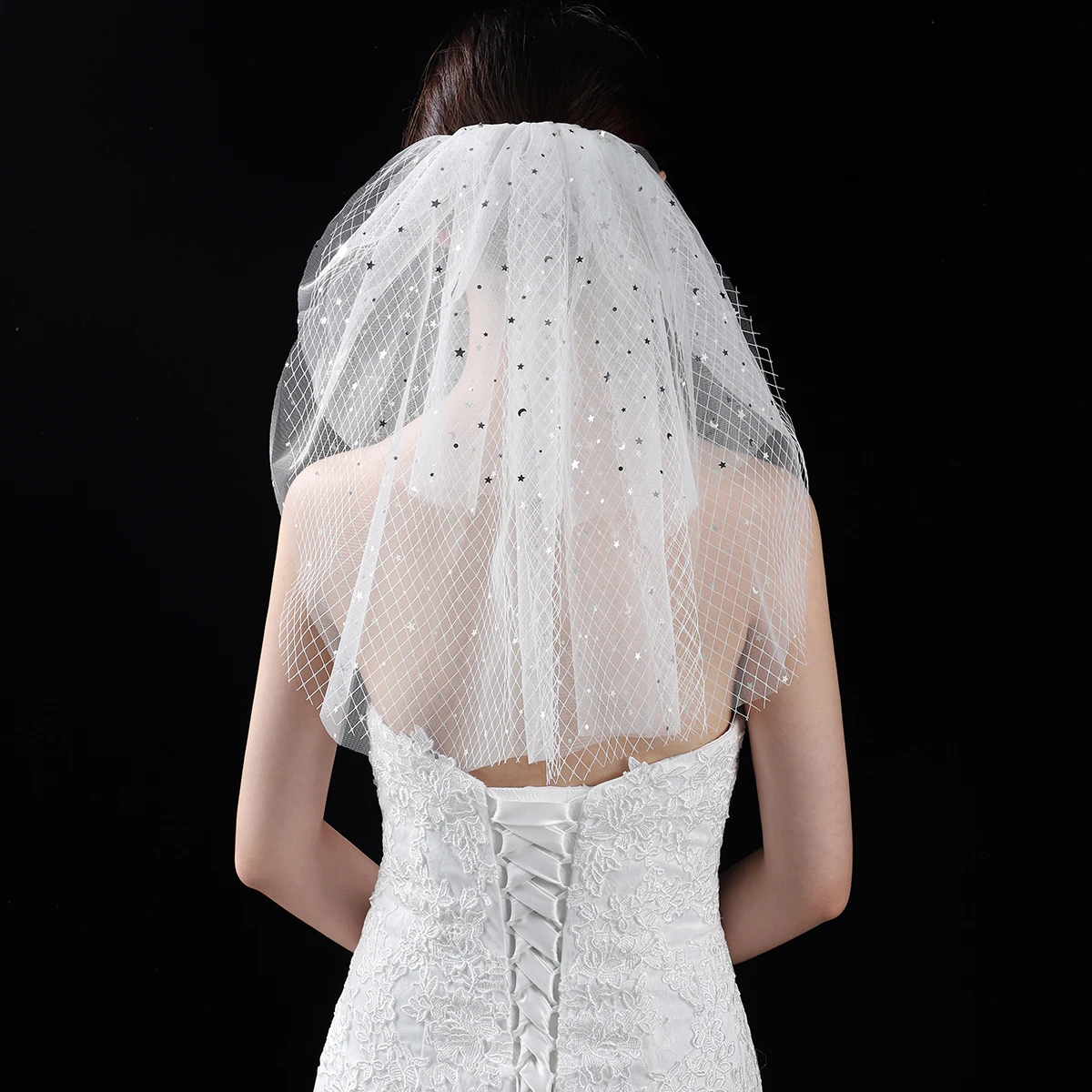 A white elegant bridal veil with a shoulder length veil adorned with sequins, suitable for women's weddings