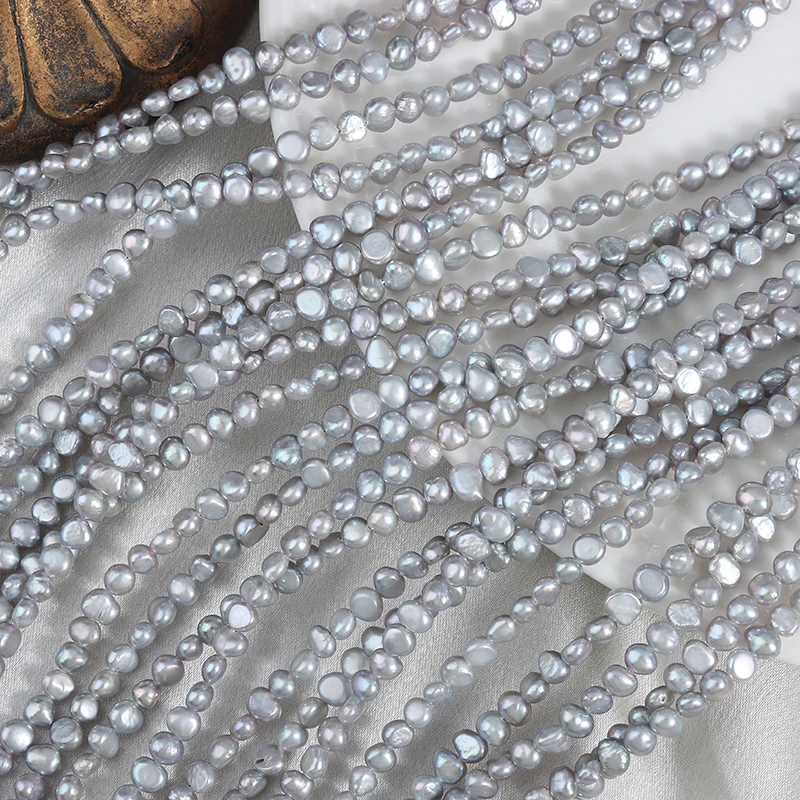 Approximately 80 irregularly shaped, two-sided polished gray Baroque freshwater pearls without nuclei, measuring 4-5mm each.
