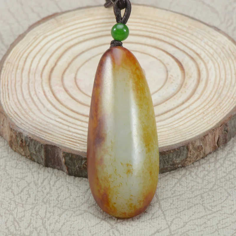 Xinjiang Hotan jade raw stone with yellow-red translucent skin, unshaped hand-held piece