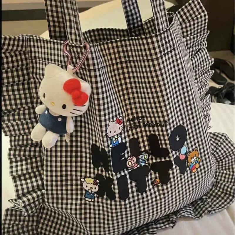 

Sanrios HelloKittys Black White Checkered Ruffled Anime Kawaii Girl Cartoon Shoulder Bag Commuting Handheld Sail Cloth Bag Gift