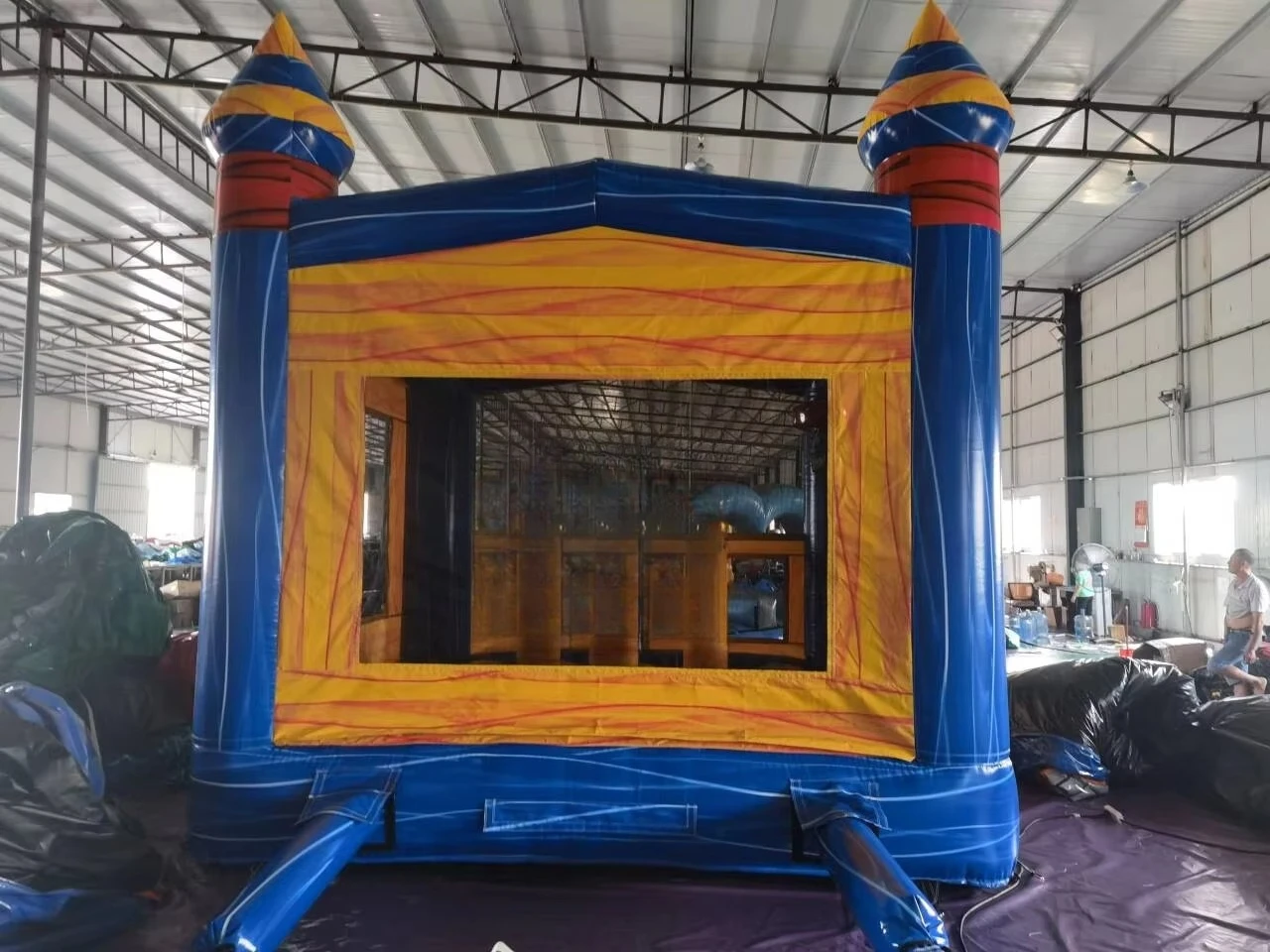 Blue and yellow inflatable bounce houses are durable jumping castles, perfect for parties, events, and outdoor entertainment