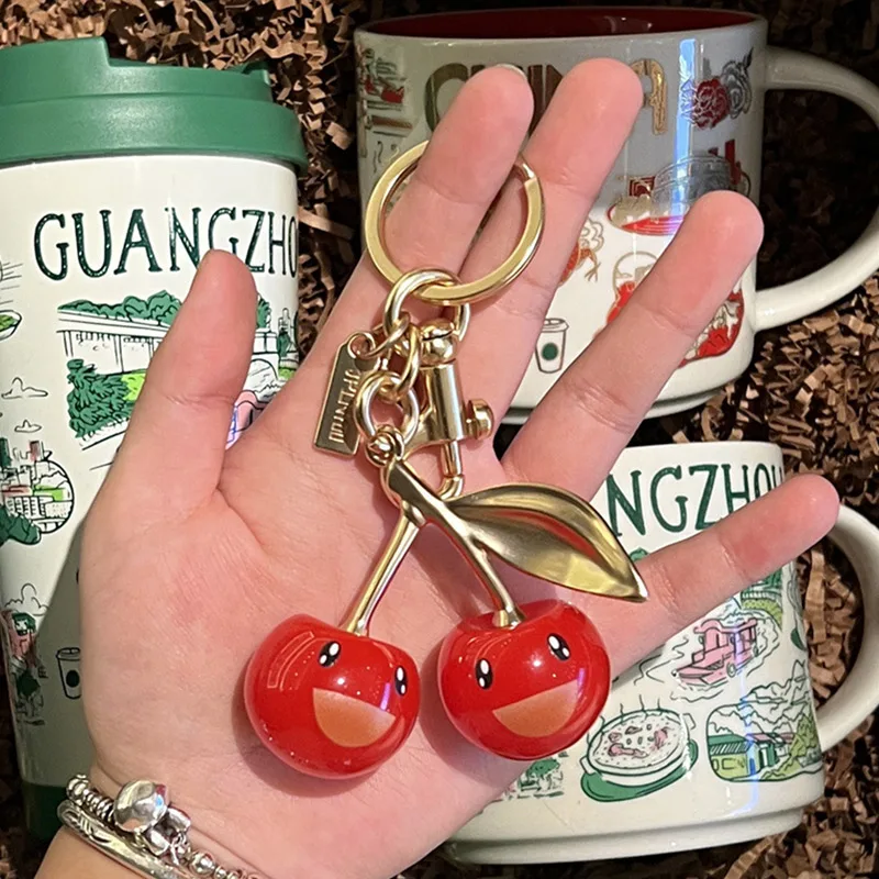 

Роскошная улыбающаяся однолистная вишневая сумка, кулон, модный брелок, элегантное украшение для ключей от машины, креативные металлические аксессуары для багажа