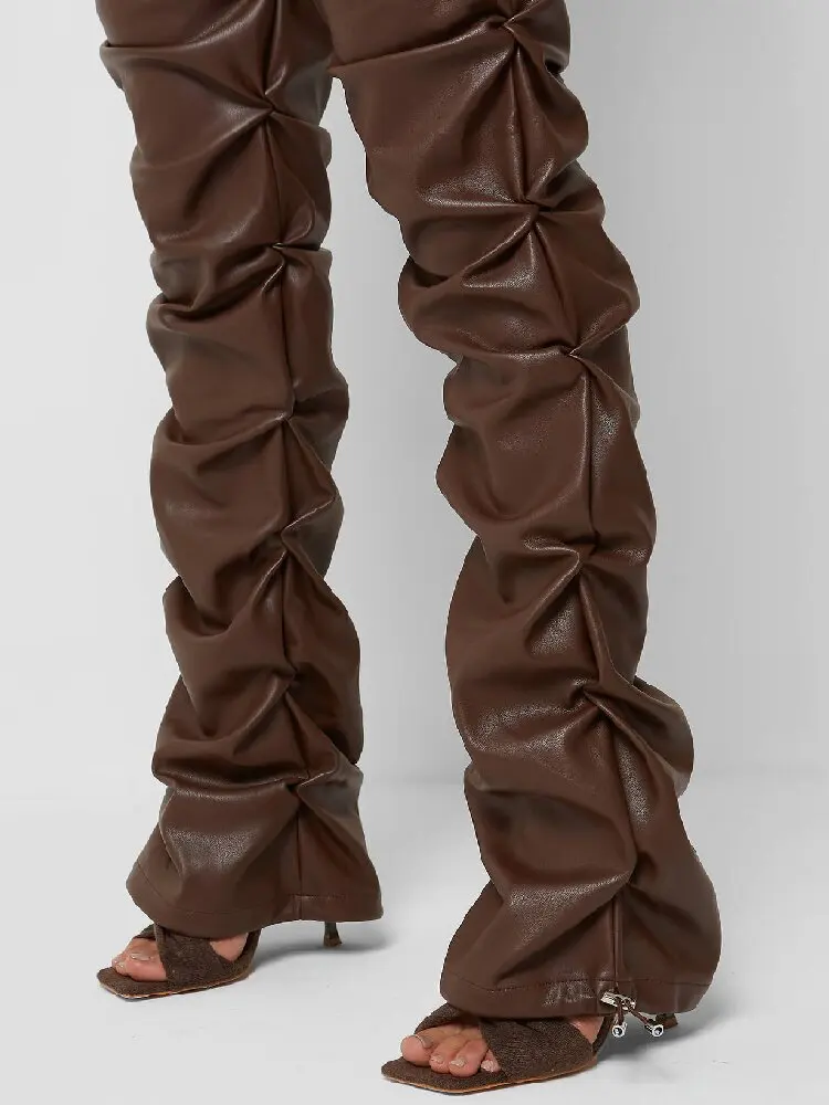 Stylish, tight-fitting PU leather trousers with a unique flared design and pleats.
