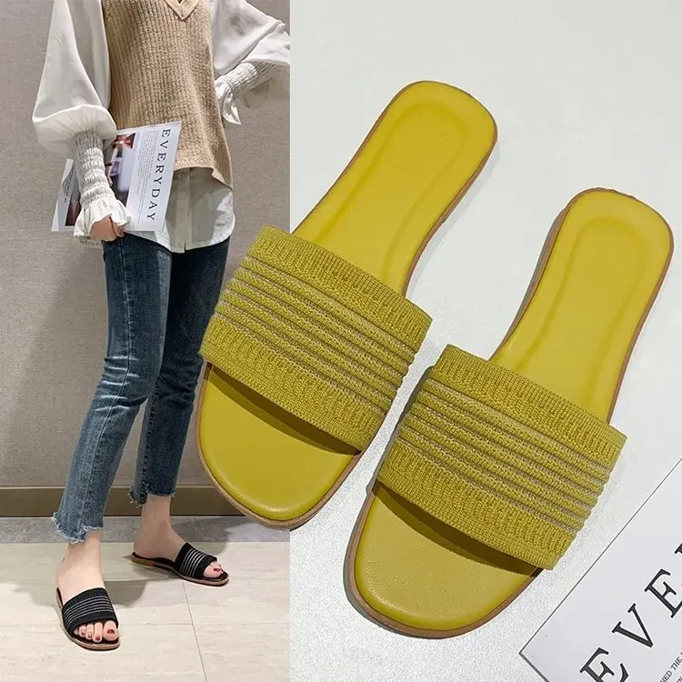 

Flat bottom cool slippers women wear 2026 summer new fashion Internet celebrity knitted font student lazy drag