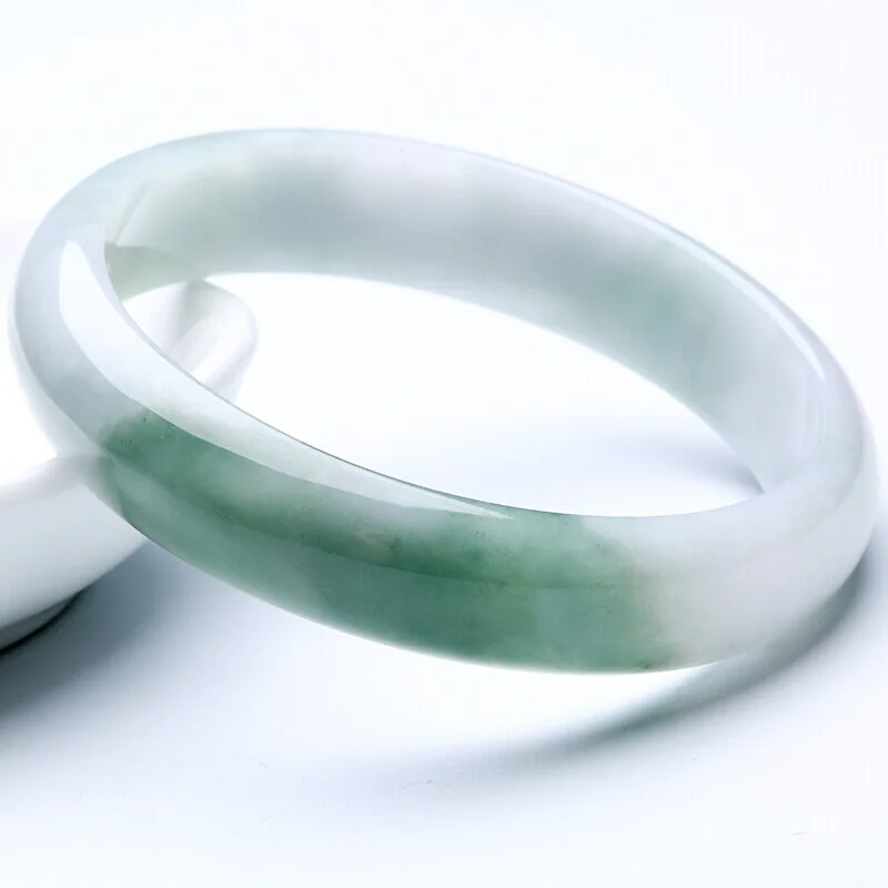 Milk-colored  semi-gloss green jadeite bracelet  with greenish hue and a smooth  round shape
