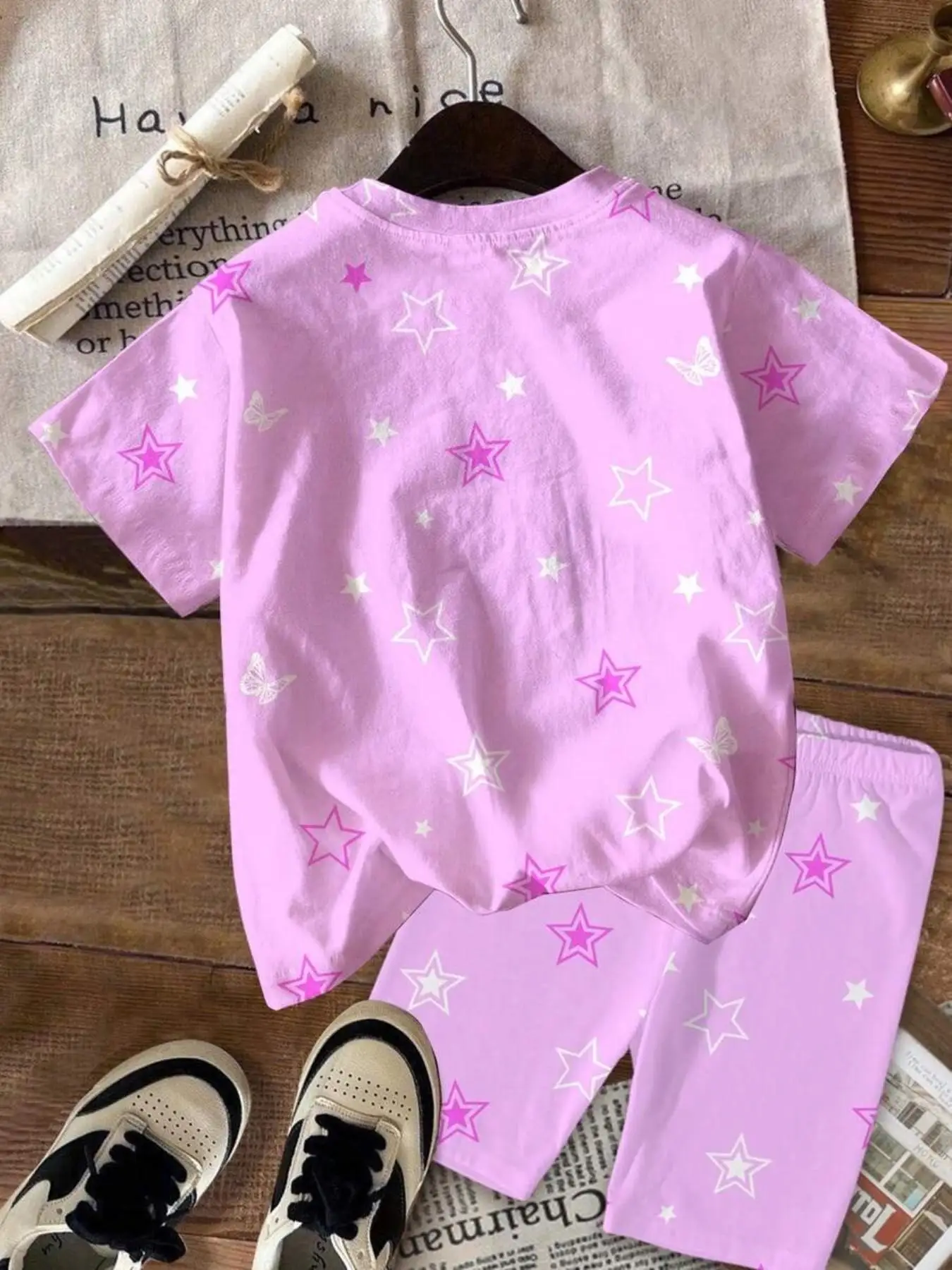Girls' K-pop-inspired two-piece set featuring an all-over print of stars and butterflies; includes a crew-neck, short-sleeved T-