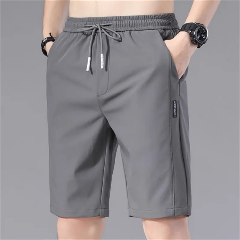 Pantalones cortos deportivos para hombre, Shorts informales de cintura elástica, holgados, con patrón liso, para correr, verano, 2024