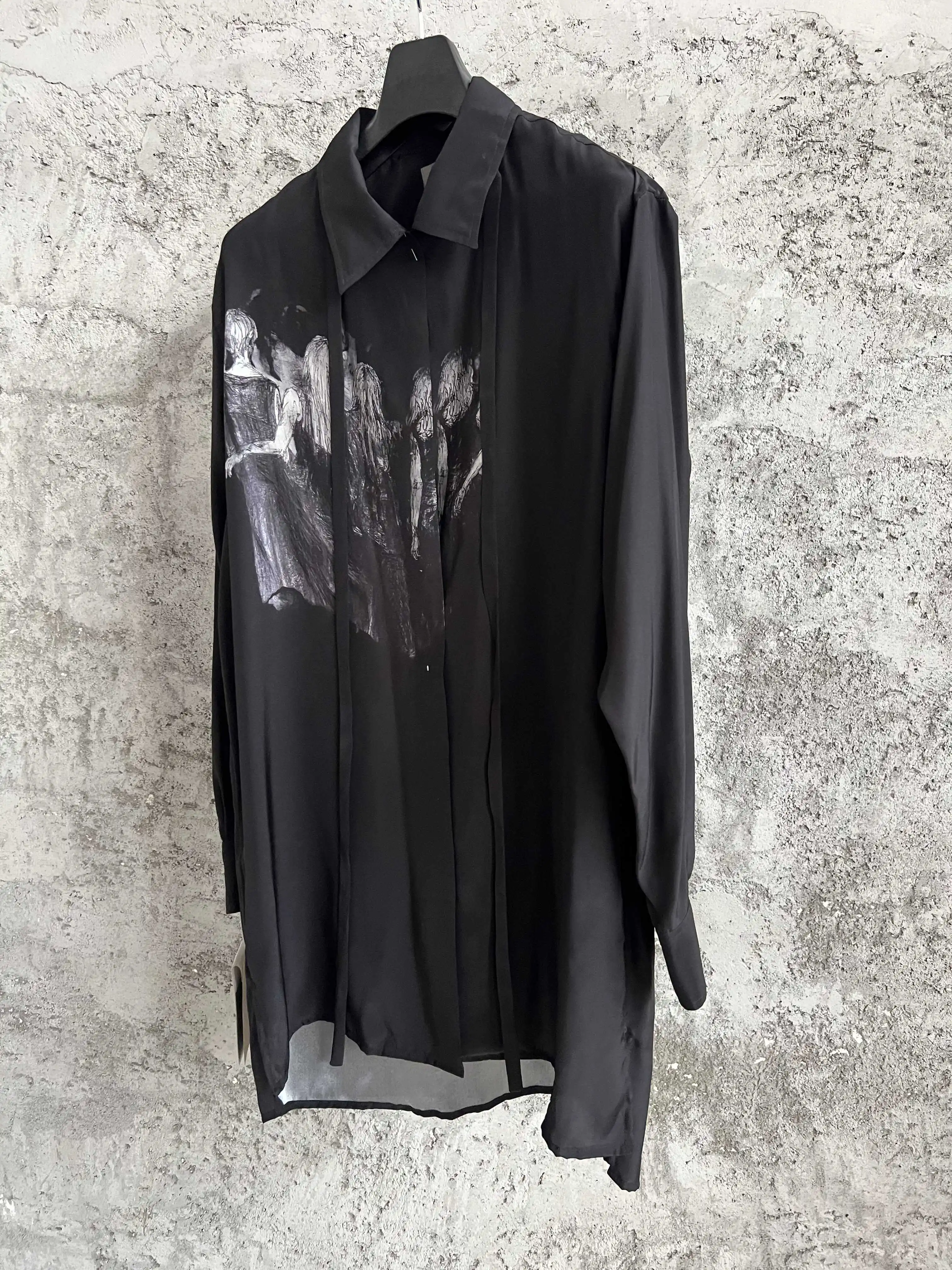 A Japanese-style original design dark style loose shirt with a short front and long back patchwork printed pattern