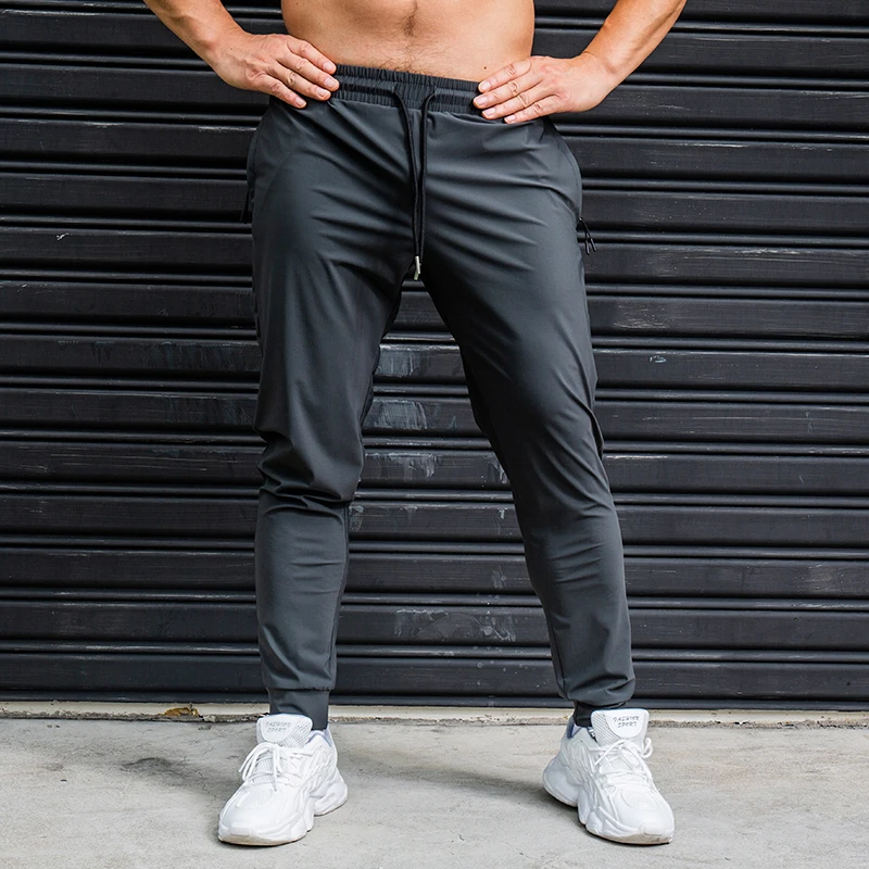 Pantalones elásticos para correr para hombre, pantalón de chándal informal con bolsillos con cremallera, para entrenamiento, trotar, Fitness,