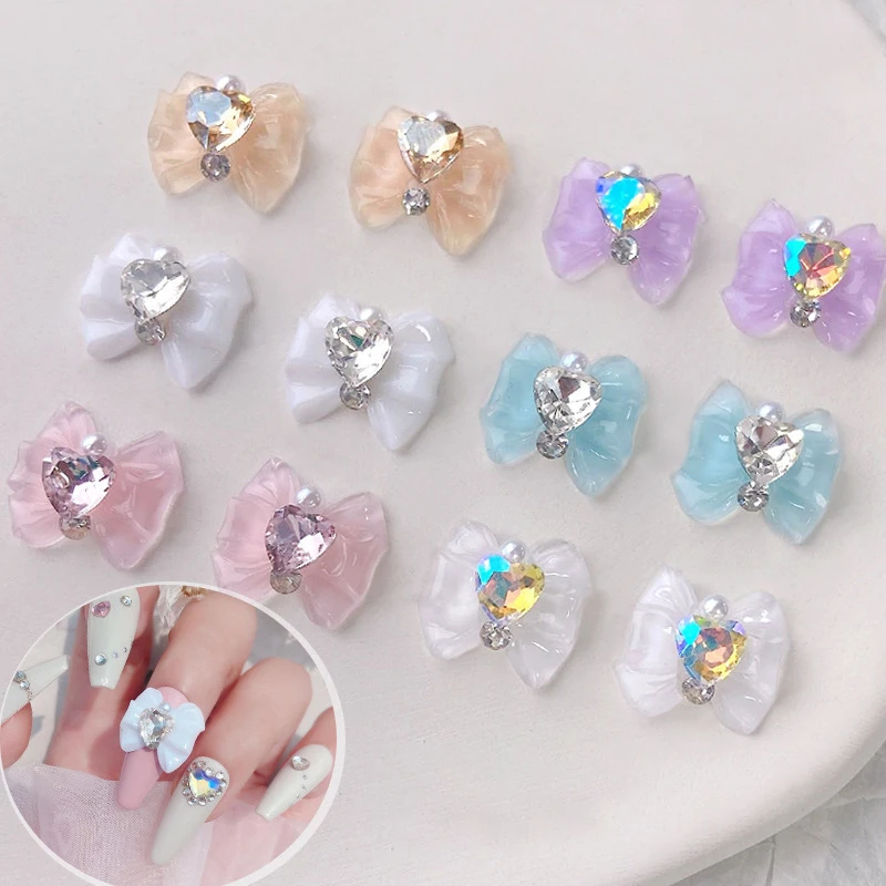Serce Rhinestone Nail Bow Charms 10 sztuk lodowy przezroczysty kryształ Bowtie biżuteria 14*13mm miłość diamentowa wstążka z żywicy klejnoty do paznokci