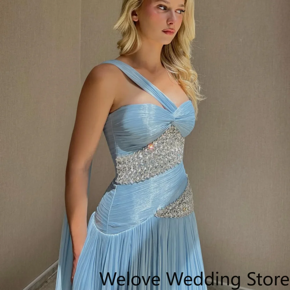 Light Blue Formal Evening Gown Featuring a One-Shoulder Neckline, Ruched Bodice, and Asymmetrical Crystal Embellishments
