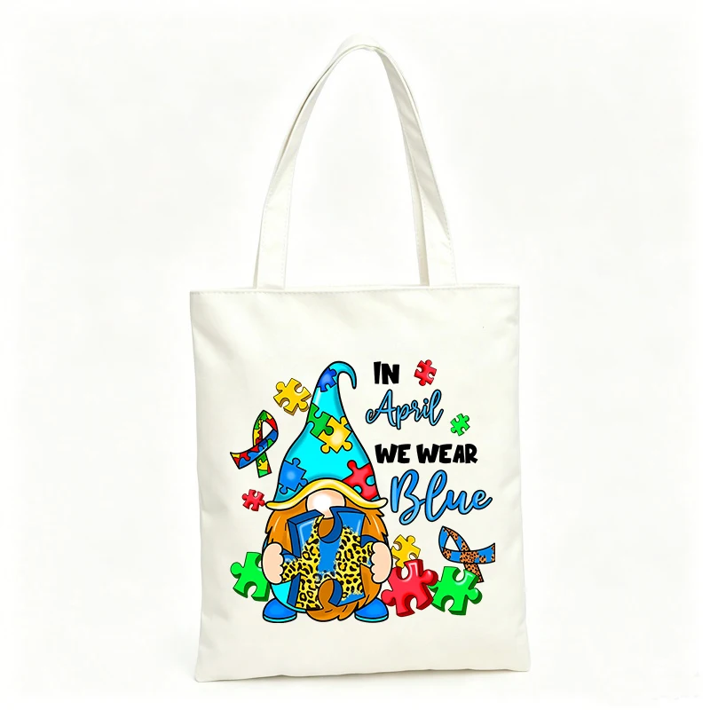 Women's canvas tote bag with gnome and puzzle piece graphic, ideal for casual daily use and awareness events
