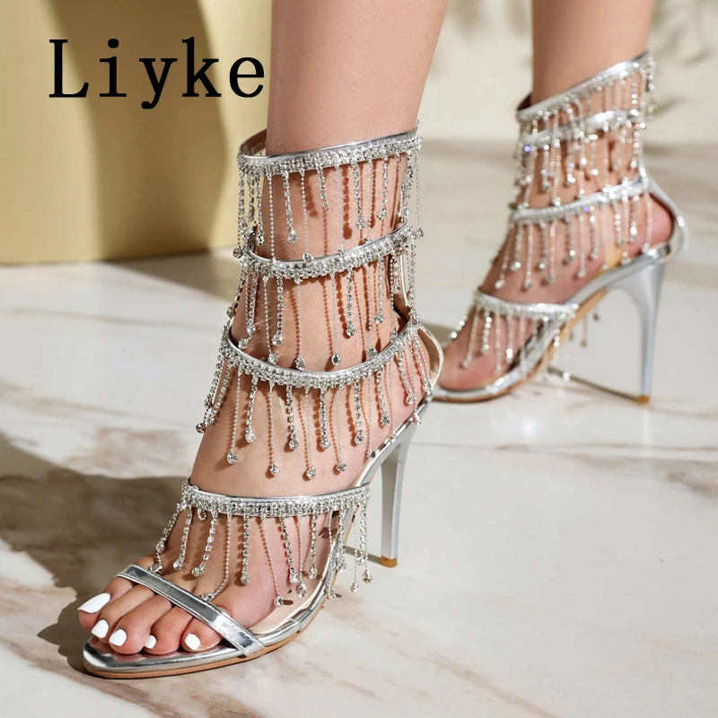 

Liyke/2026, новые женские сандалии на высоком каблуке золотого, серебряного цвета с открытым носком и стразами, свадебные туфли для выпускного вечера, с кисточками на щиколотке и ремешком на молнии