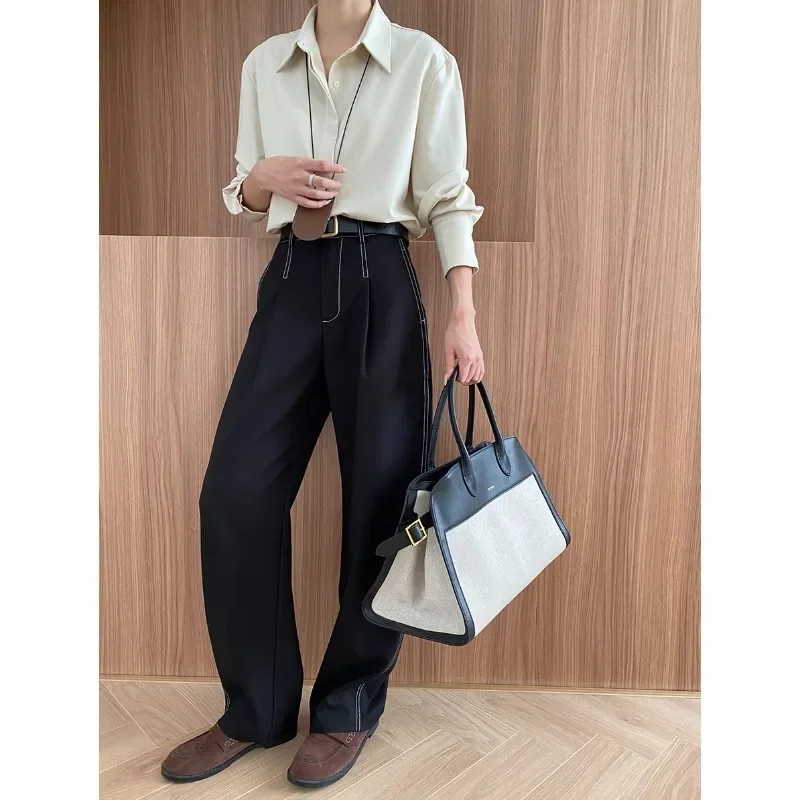 Deconstructed, split exposed outer seams, straight, loose, drapey casual pants with a yuppie vibe.