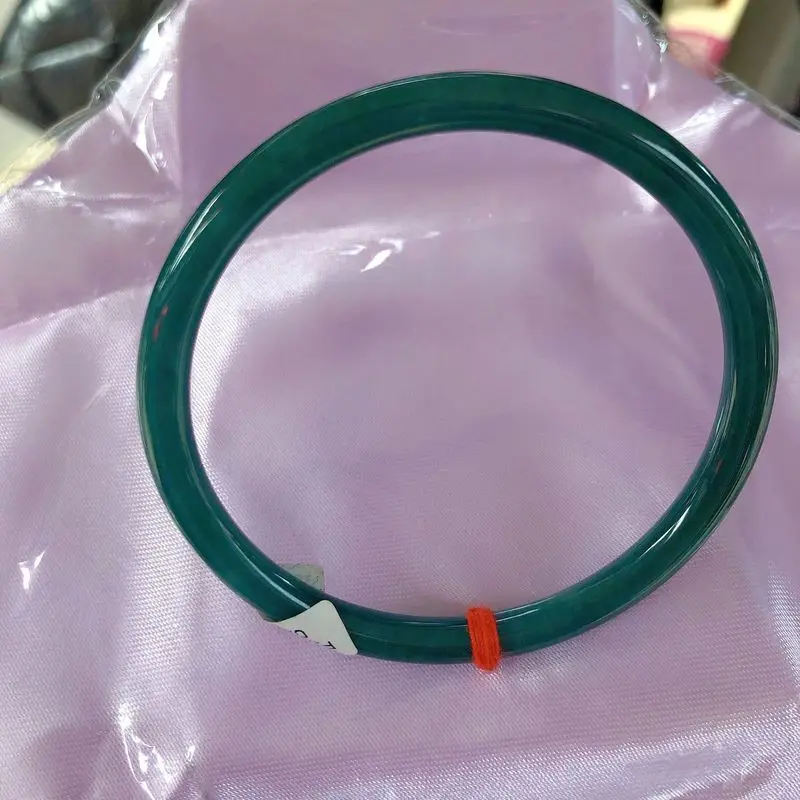 Jadeite A-grade, fine round bangle with a jingling ring featuring a creamy icy texture and a blue-tinged water-like luster