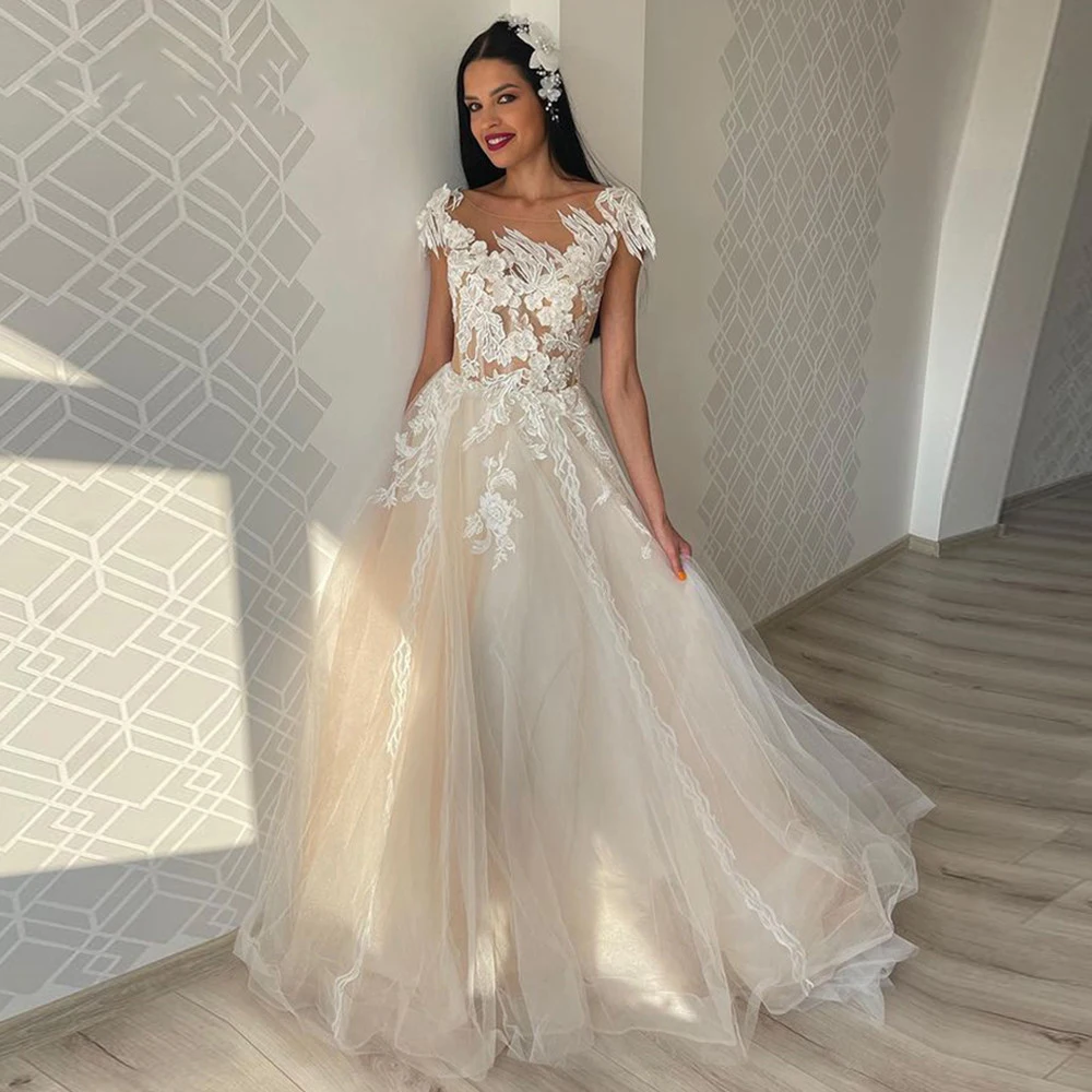 

Illusion Appliques Cap Sleeves Tulle Wedding Dresses 2026 Sheer Neck Pearls Princess Beach A-Line Bride Dress vestido de noiva