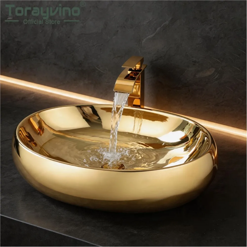 Torayvino Gold Vessel Sink Set Bathroom Ceramic with Deck Mounted Waterfall Faucet Modern Oval Countertop Basin for Hotel Villa
