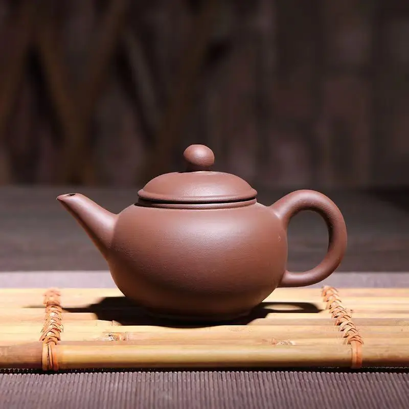 A kung fu tea maker makes a teapot in yixing city, China