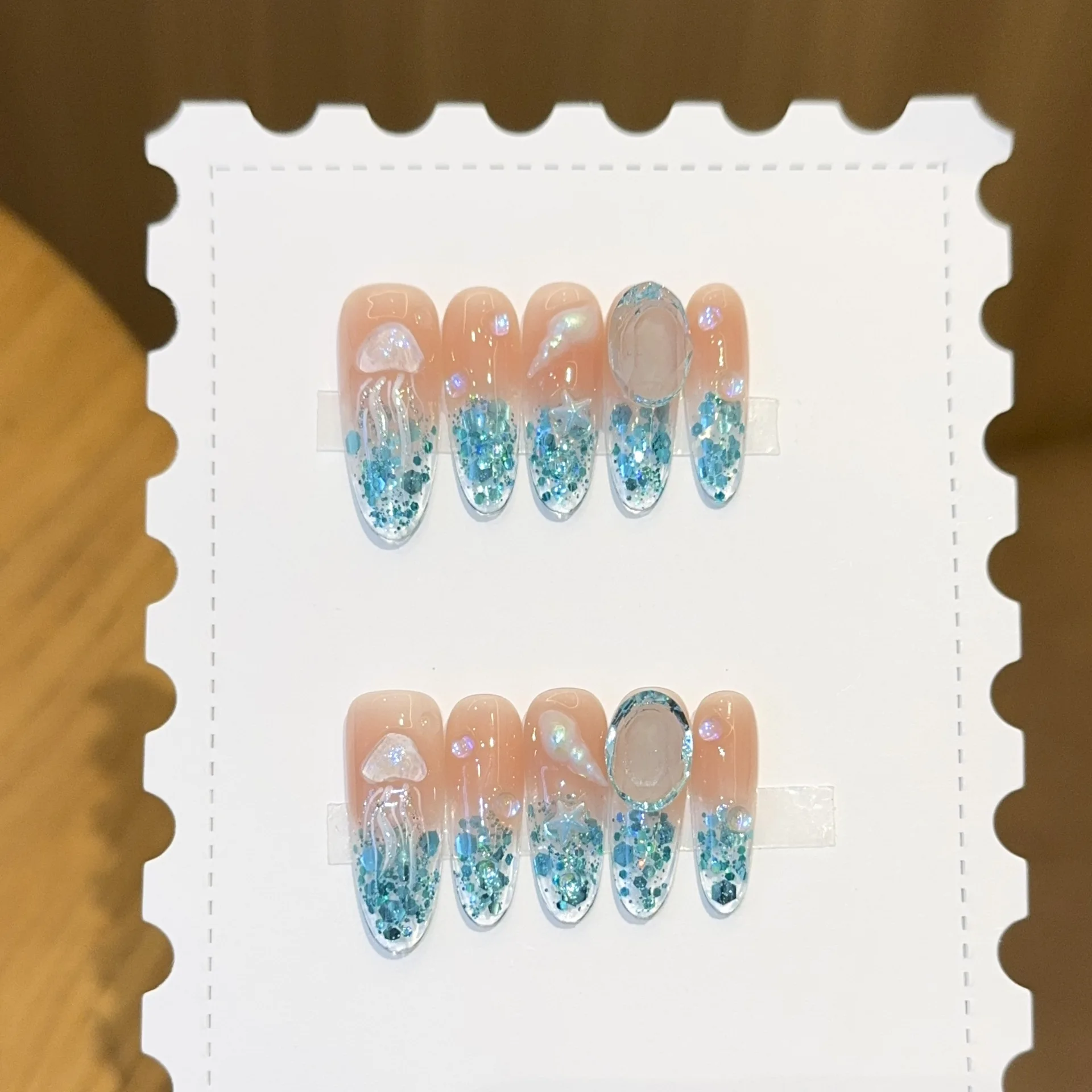 

10pcs Nude Base Blue Glitter Handmade Press on Nails 3D Jellyfish Ocean Press on Nail Long Oval Fake Nail for Women False Nail