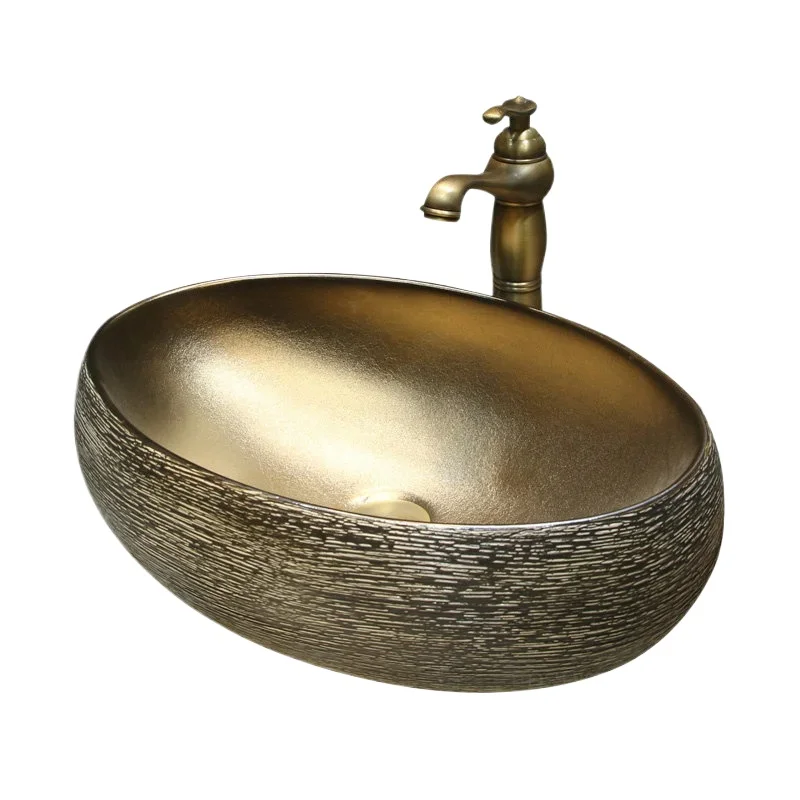 

Ceramic bathroom sink, golden countertop basin, creative retro home, hotel washbasin