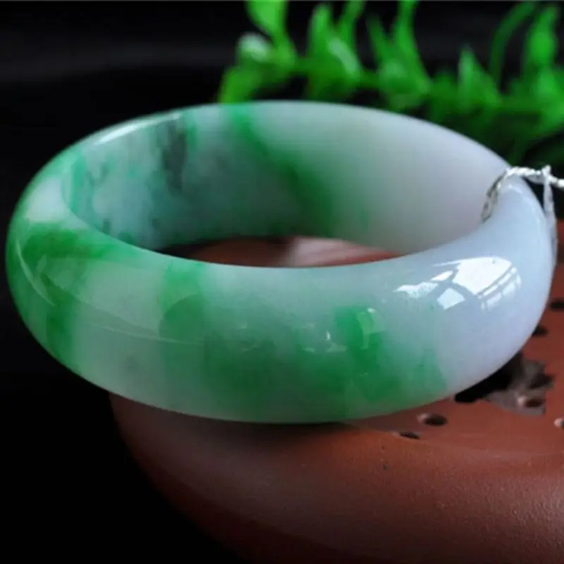 Natural Burmese ice-type light jadeite bracelet with spring-colored patterns wide round design featuring a bright green