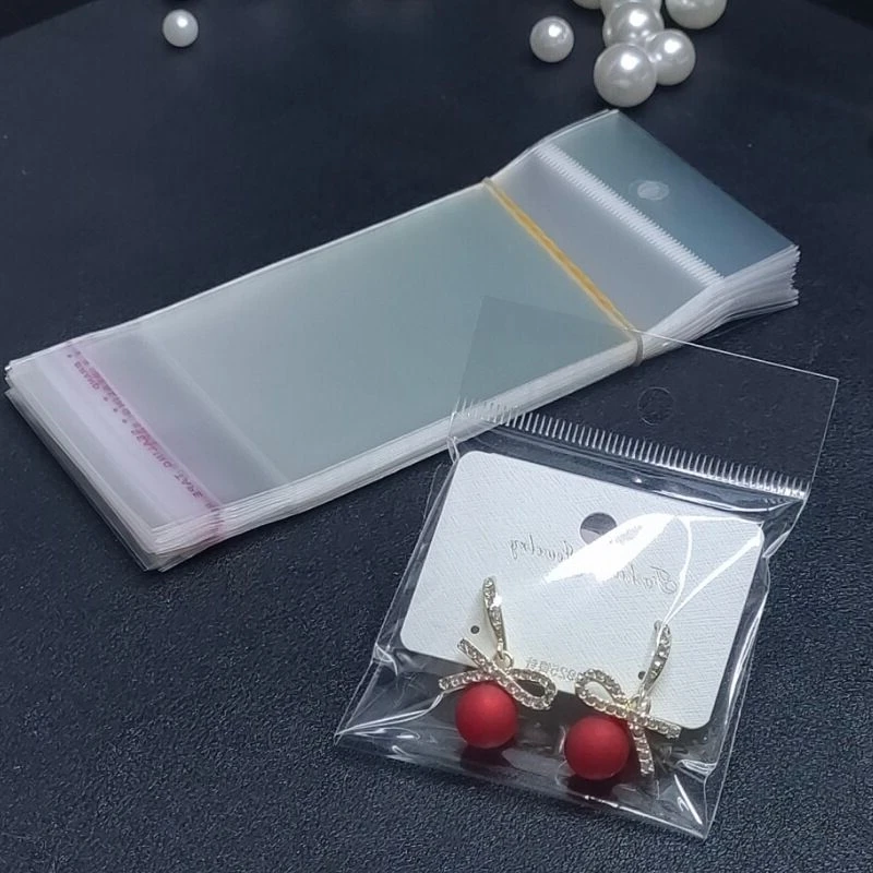 100 transparent plastic hanging self-adhesive bags, OPP self sealing bags, jewelry candy bags, gift biscuit sales bags