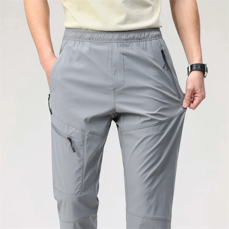 قسط عارضة الأزياء في الهواء الطلق للماء الرباط جيوب كثيرة مستقيم الرجال تنفس الرياضة السراويل الطويلة تخفيف السراويل