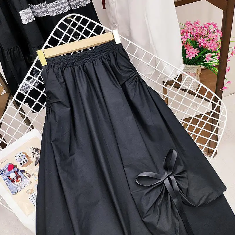 Faldas largas de primavera para mujer, faldas por debajo de la rodilla con bolsillo y lazo negro Vintage para mujer, faldas plisadas irregulares de cintura alta, ropa de verano para mujer