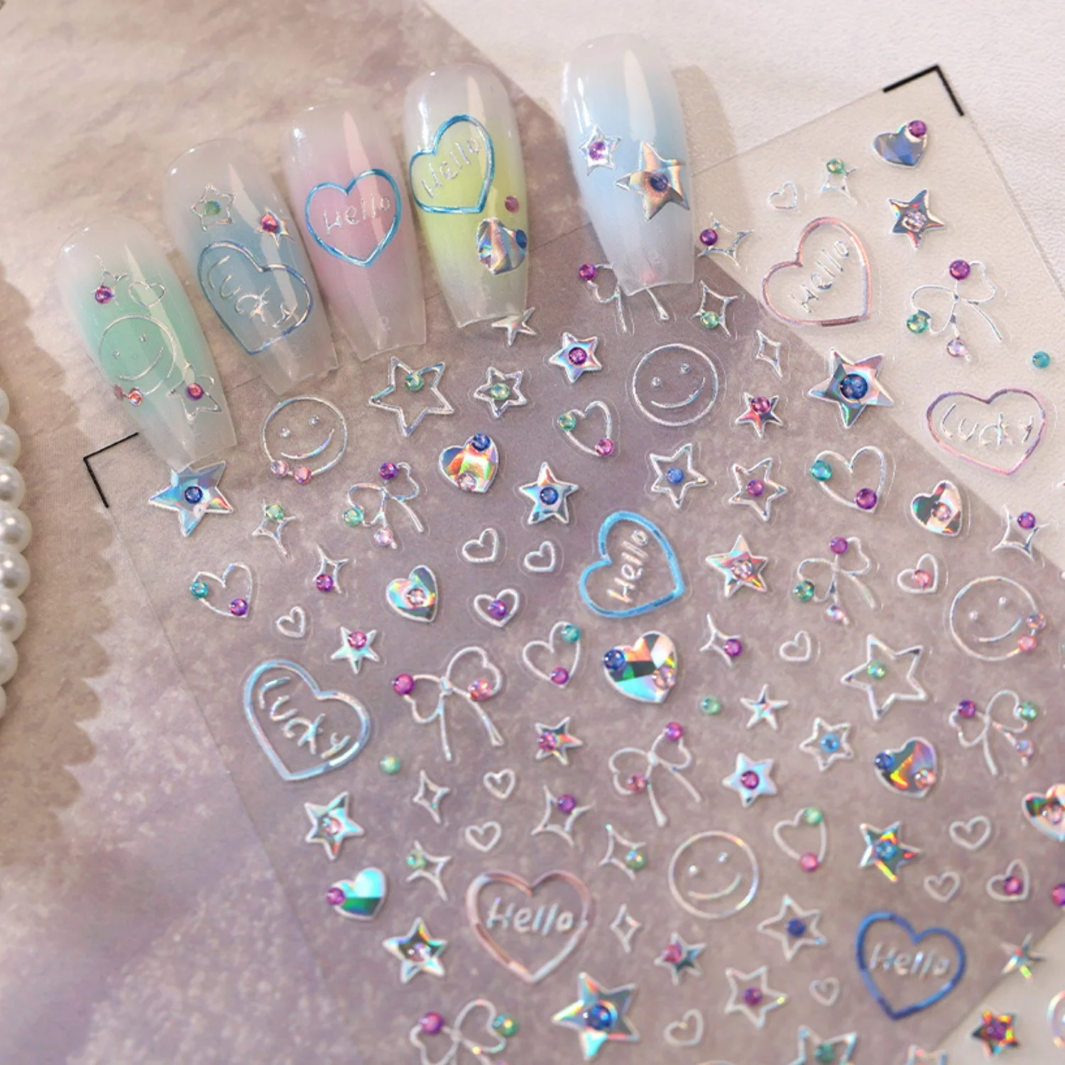 Glänzende Laser-Folie 5D Nagelkunst-Aufkleber Hello-Schrift Herz Smiley Gesicht Schleife Fünfzackiger Stern Nagelsticker Selbstklebend Lebendige Maniküre