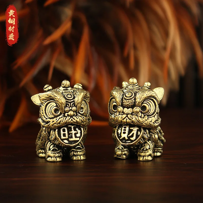 A pair of brass lion figurines, designed to bring good fortune and prosperity, perfect as tea ornaments or decorative pieces for