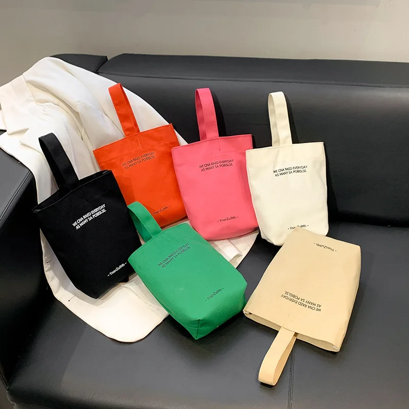 2023 new minimalist style mini portable canvas bag lunch bag candy color kettle wrist strap plain canvas bag