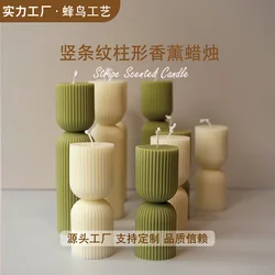 Handmade scented candles with striped columns. White and green decoration. Blue wind chimes scented candles accompanied the cere