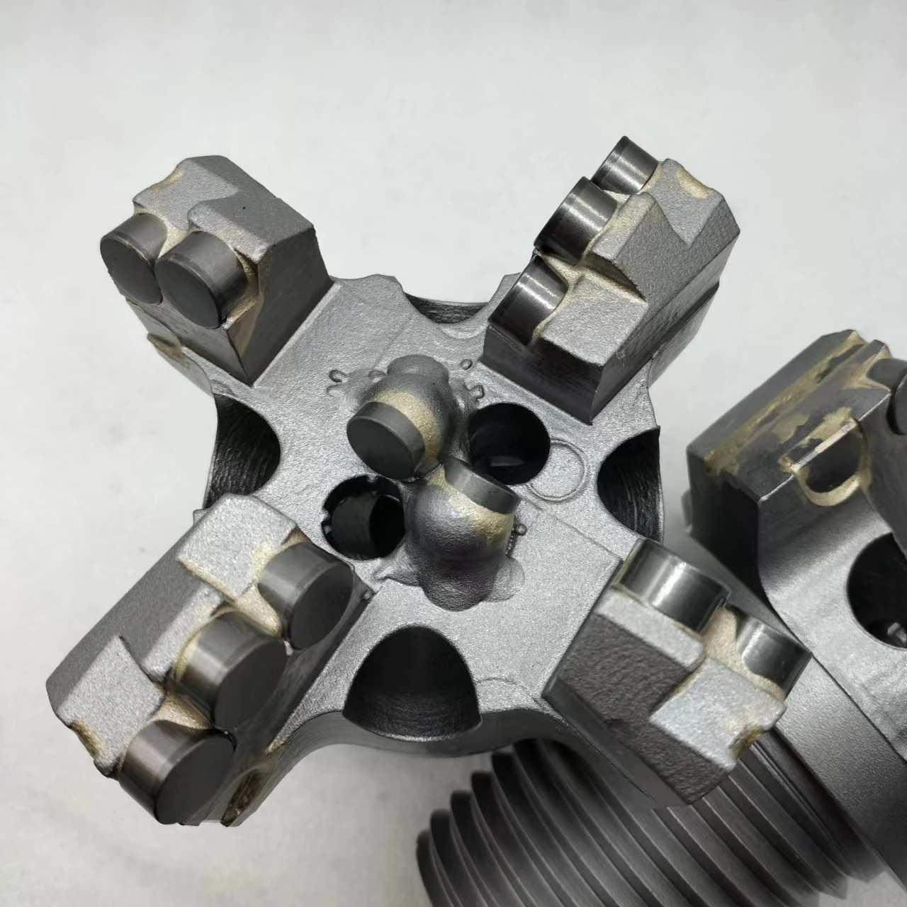 Customized four-wing concave coreless drill bit