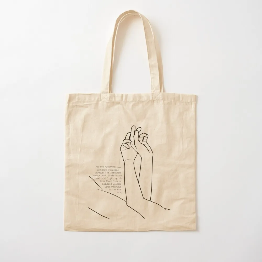 their hands meet, and light spills in a flood like a hundred golden urns pouring out of the sun. Tote Bag