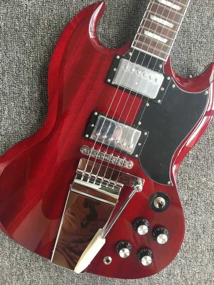 In stock SG electric guitar, mahogany red transparent body, large rocker vibrato chord plate, black guard, LP pickup,