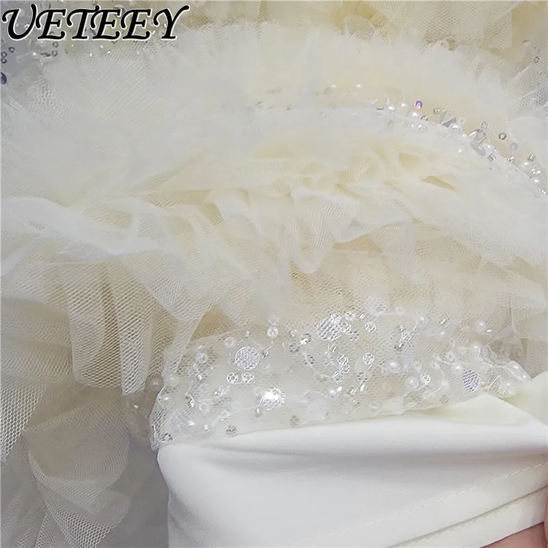 กระโปรงยาวทรงเค้กแต่งระบายผ้าทูลล์ประดับเลื่อมเอวสูงยางยืด สไตล์แฟชั่นใหม่รับฤดูใบไม้ผลิปี 2026 สีแอปริคอต ดีไซน์อเนกประสงค์สำหรับผู้หญิง