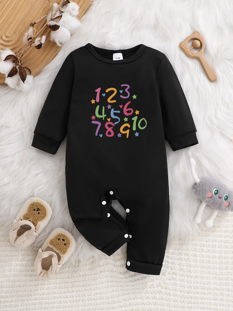 A baby long-sleeved onesie with interesting letter prints. It features a buttoned design for easy putting on and taking off