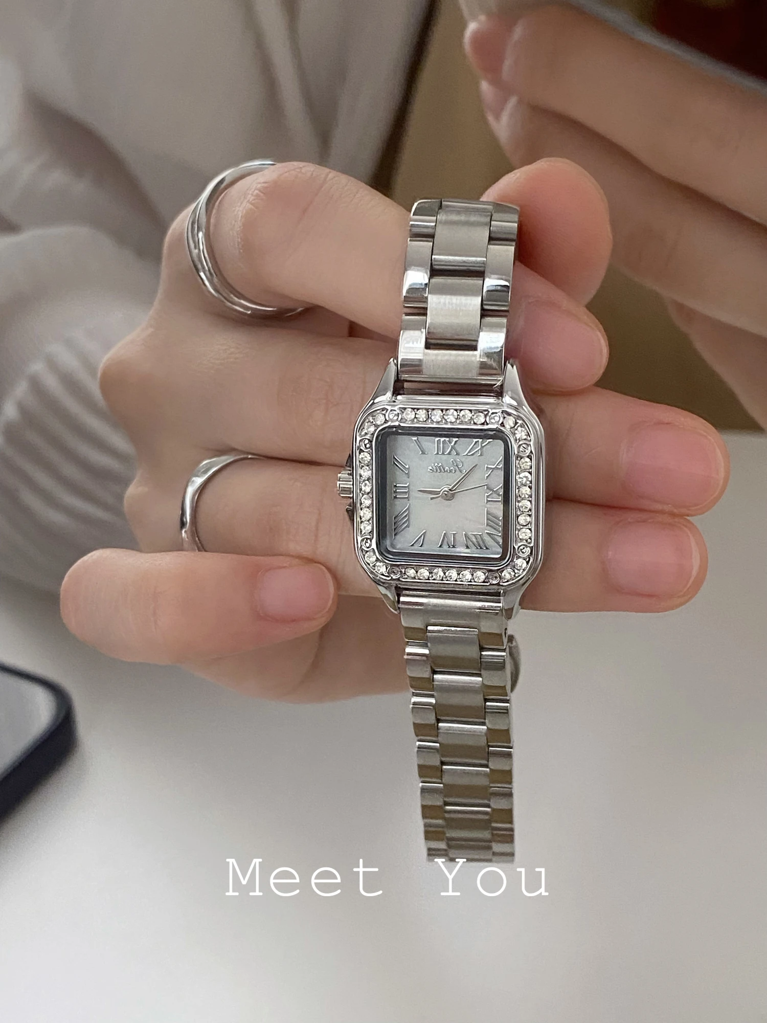 

Elegant women's wristwatch, square design, delicate small dial, sophisticated and stylish steel strap, women's accessory.