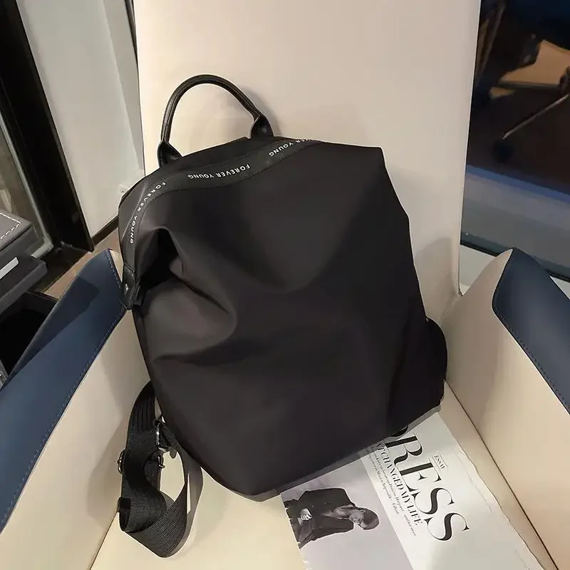 Gran oferta de la temporada, nueva mochila minimalista de lona de nailon a la moda, bolso Universal de doble hombro para libros, Simple y versátil