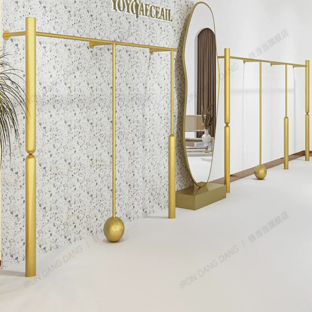 

Women's clothing store shelf display rack creative wall mounted golden clothing display rack dedicated clothing store hanger