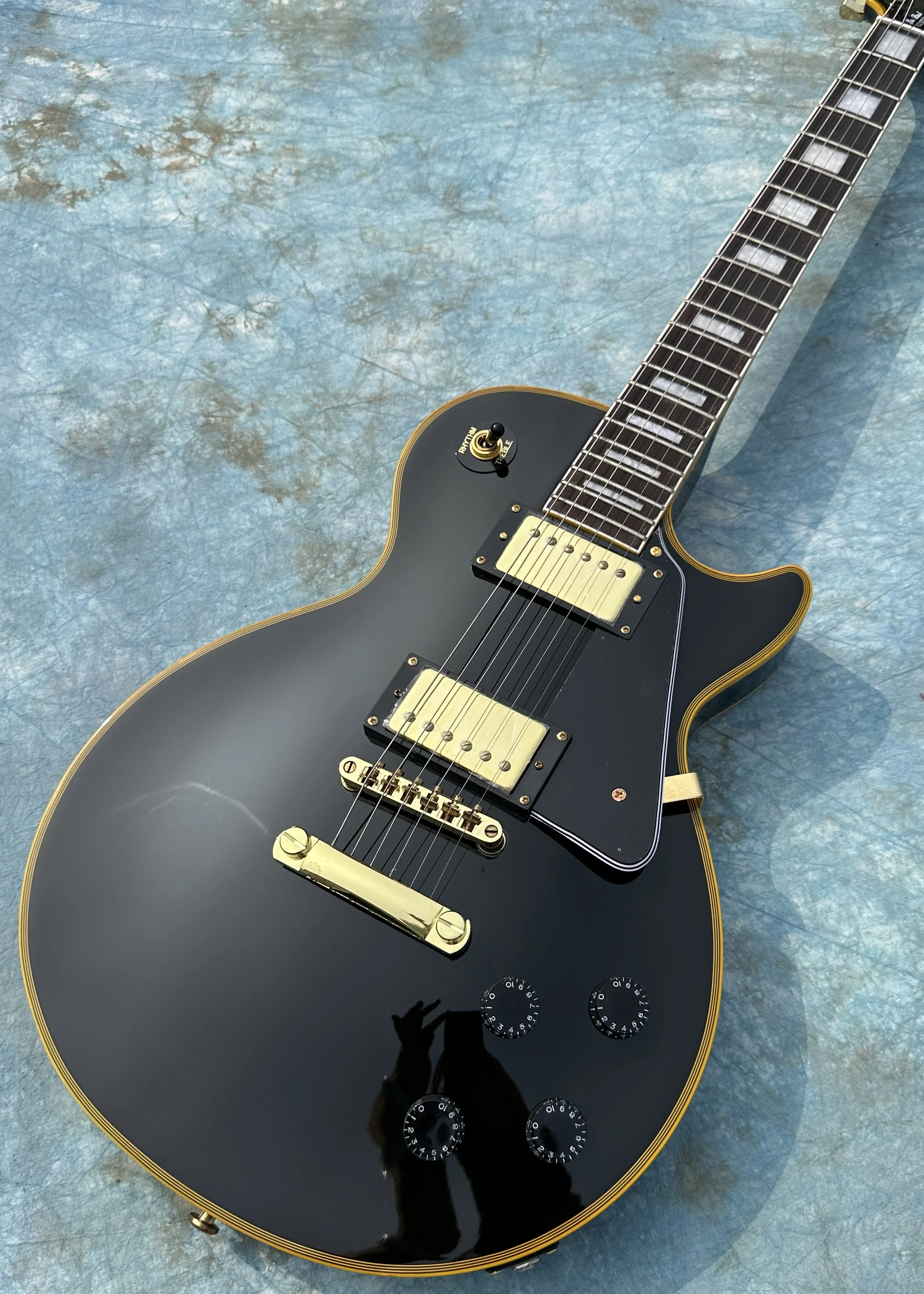 Customized electric guitar, black caston, yellow logo and body binding, gold accessories, lightning package