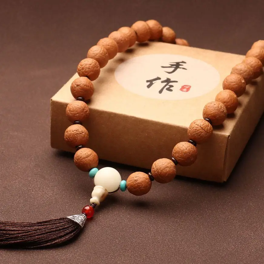 

Authentic Natural Nepali Phoenix-Eyed Bodhi Holds A Bead Bracelet Tassel.