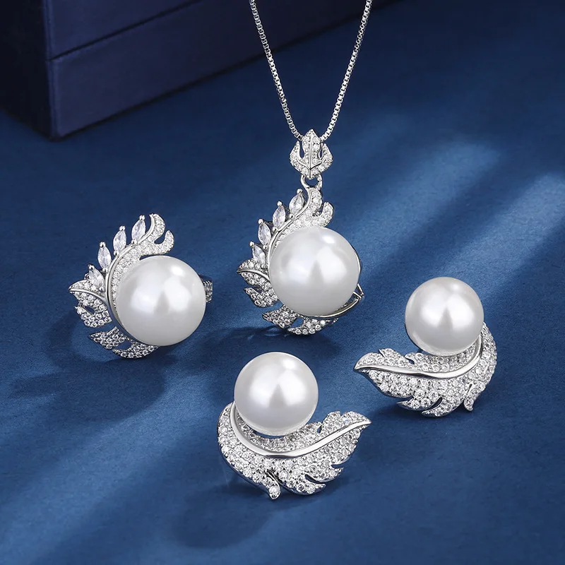 

Korean-style jewelry set: feather white pearl-shaped earrings, silver-white edge pendant necklace, silver-white edge ring, three