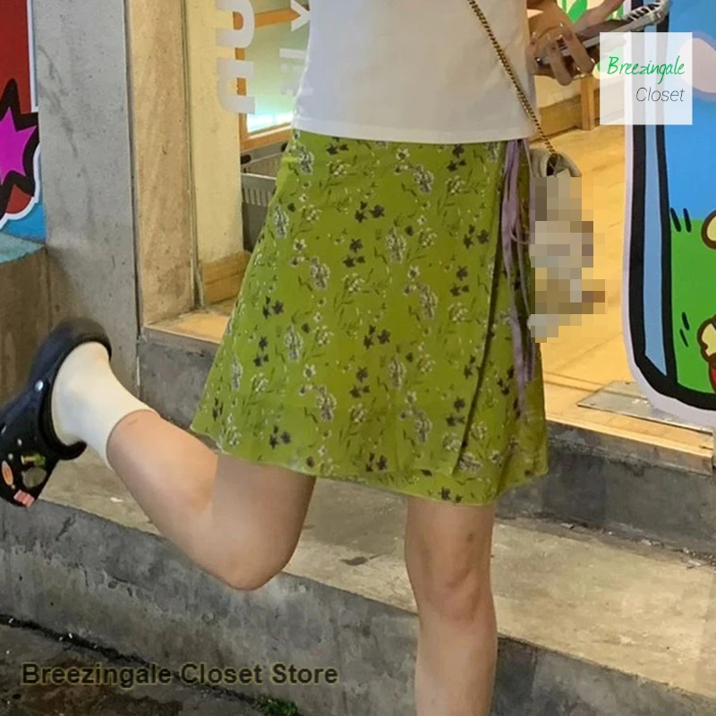 

Korean design sense green floral lace-up skirt female spring and summer new fashion sweet and fat mm printed A-word skirt.